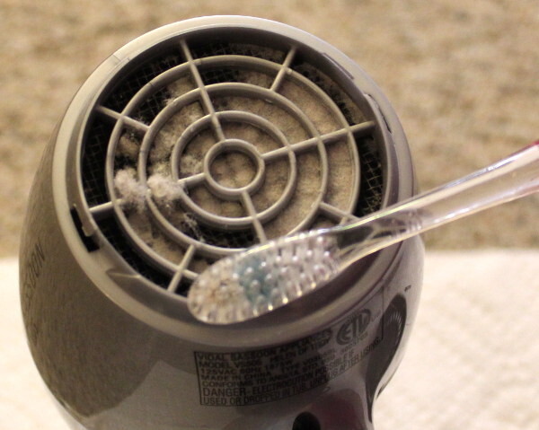 Use an old toothbrush to get rid of the dust in the back of your blow dryer.