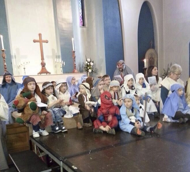 The kid who decided to be Spiderman in this nativity scene