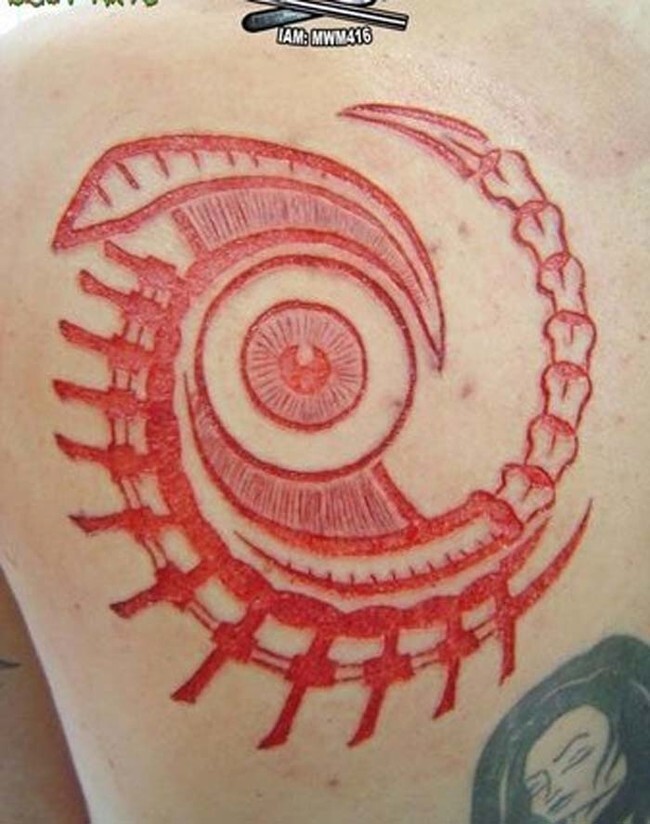 This body modification is called "scarification." Scarification involves creatively cutting the skin in intricate patterns. Once it heals, the scars leave behind a picture.