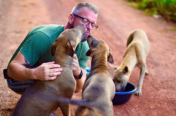 Michael J. Baines feeds about 80 stray dogs in Chonburi, Thailand every day
