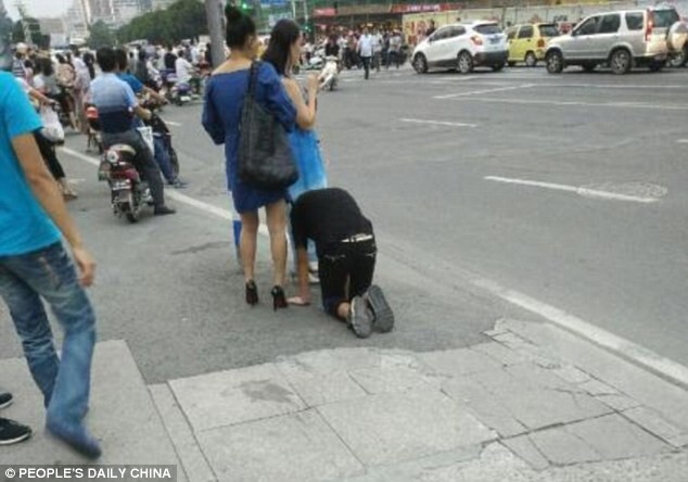 Shocking moment a woman takes her male companion for a walk on a DOG LEASH in China