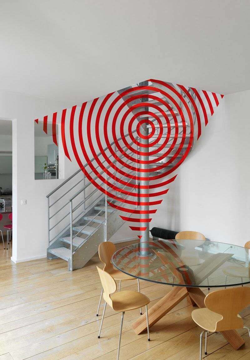 While this image may look photoshopped into this living area, the unique design was created by Swiss-born artist Felice Varini. 