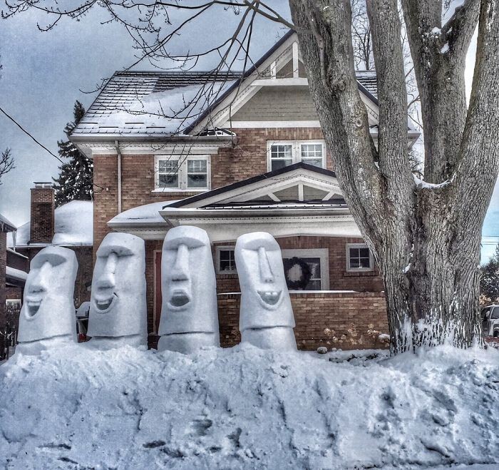 A quartet of Easter Island snow sculptures smiling for the people walking by. Winter of 2014-2015
