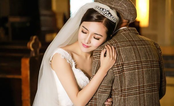 Ms. Fu hugs her grandfather as they walk down the aisle in a church