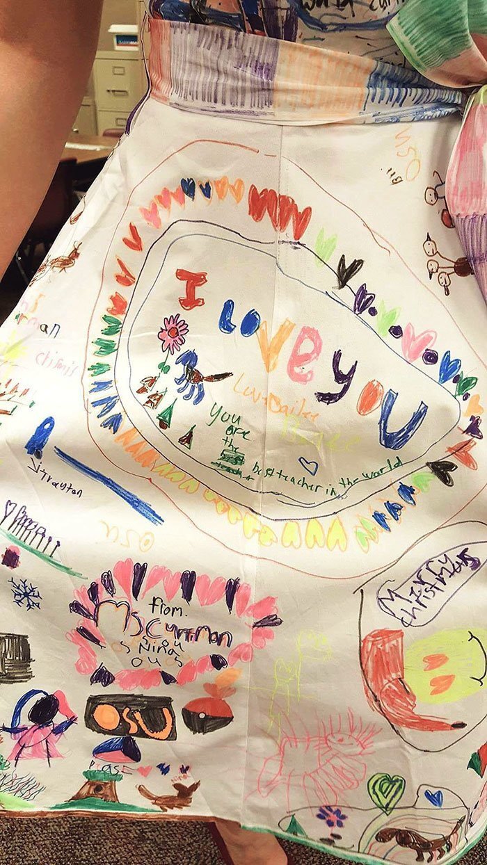 For the second time, Haley set up a white dress in her classroom and allowed her students to draw on it