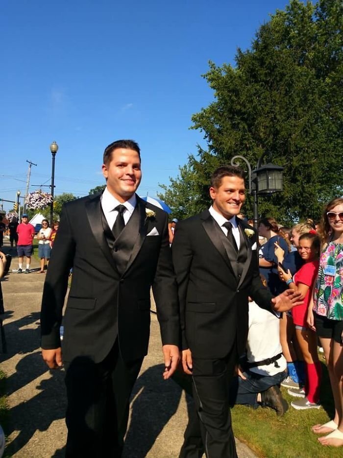 The brides wore matching dresses while the grooms rocked identical tuxedos