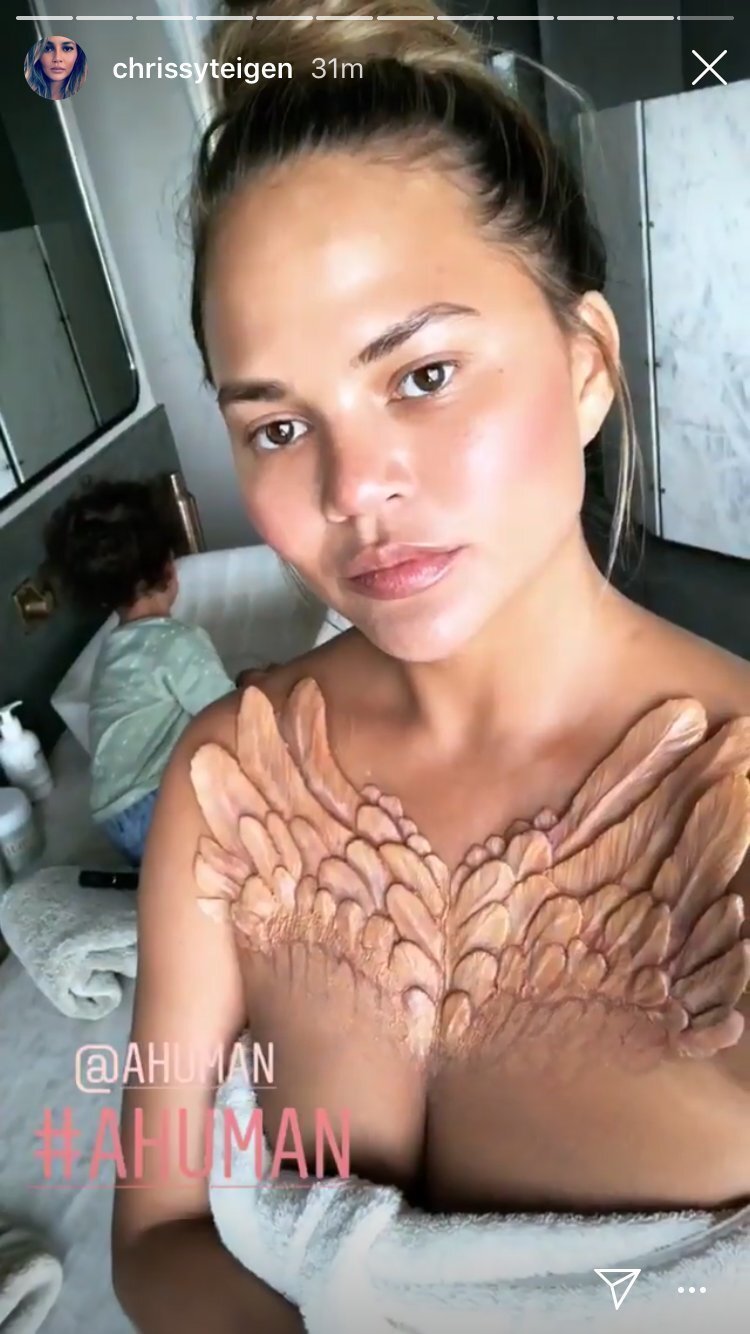 Chrissy Teigen, for example, showed feathers emerging from under her chest