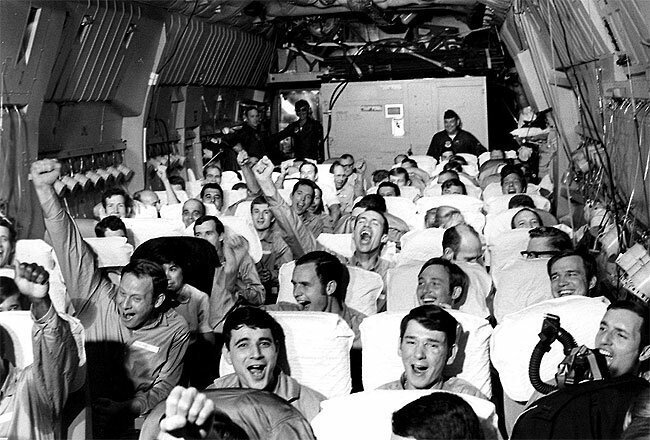 Newly freed prisoners of war celebrate as their C-141A aircraft lifts off from Hanoi, North Vietnam, on Feb. 12, 1973, during Operation Homecoming