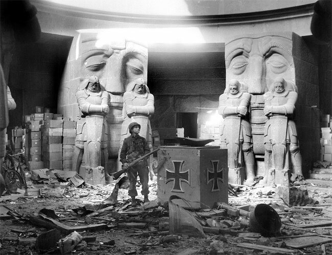 American soldier standing in the rubble of The Mounument to the Battle of the Nations near Leipzig Germany, 1945