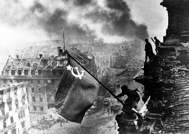 Soviet troops fly the Hammer and Sickle above the Reichstag in Berlin, May, 1945