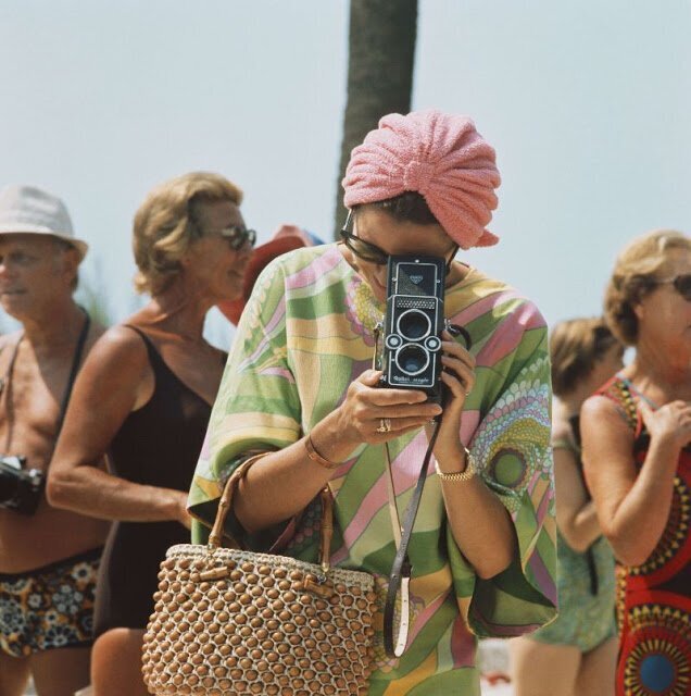 1972. Princess Grace of Monaco taking a photograph at a swimming competition at Palm Beach, Monte Carlo.