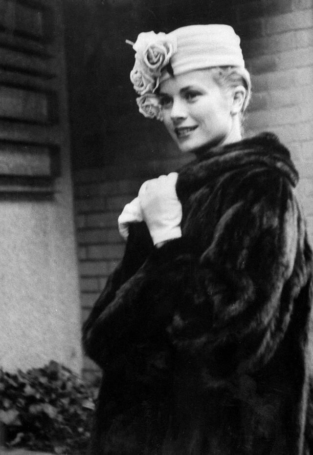 1956. Grace Kelly posing outside her apartment building before leaving for Monaco. Photo by Lisa Larsen.