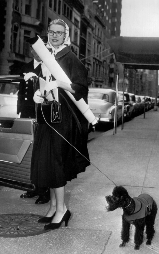 1956. Grace Kelly, wearing a Hermès headscarf, with her beloved French poodle Oliver in New York.