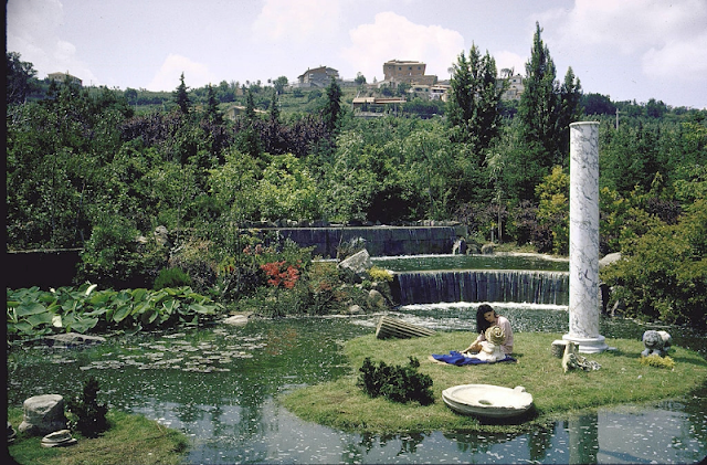 Sophia Loren plays with her niece on the litttle island of the man made pond on the grounds of her villa.