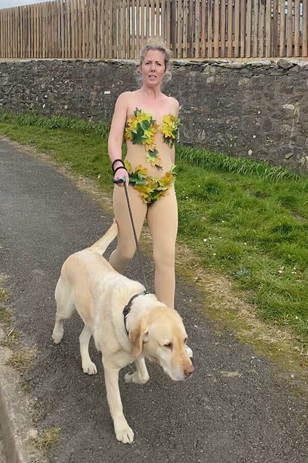 Woman Wears Bizarre Costumes While Walking Her Dog During The Quarantine And He Looks Embarrassed