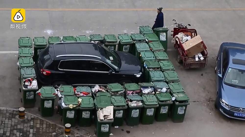 В опубликованном видеоролике видно, как работник блокирует нелегально припаркованный автомобиль по периметру полными мусорными баками. 