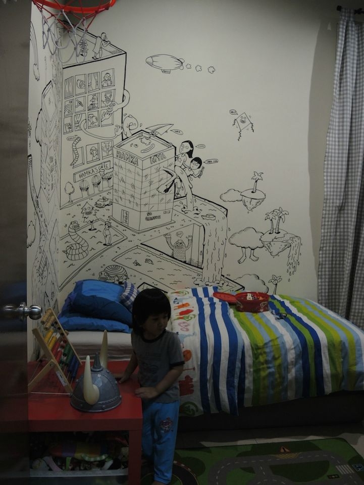 Креативный отец рисует воображаемый мир на стенах комнаты сына