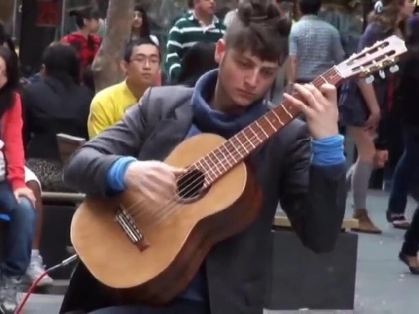 Уличный исполнитель с гитарой 