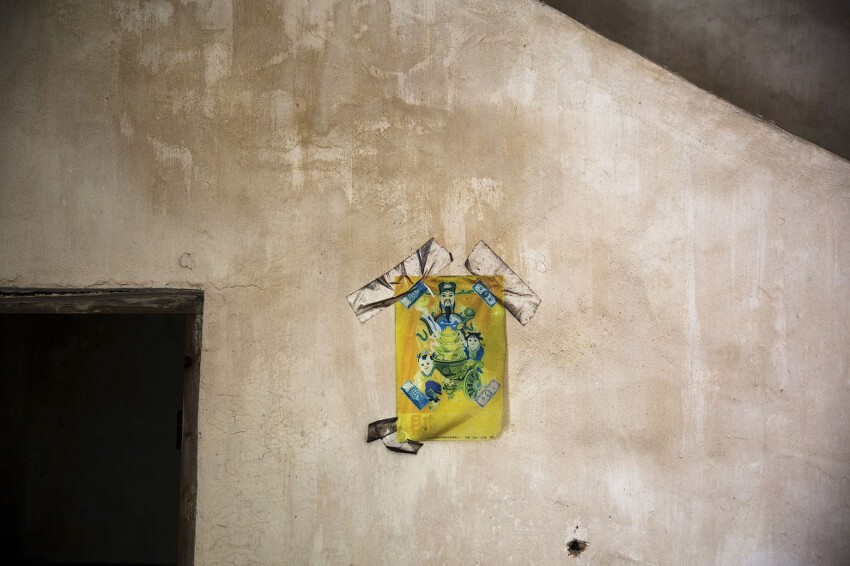 Китайский Бог Фортуны на стене заброшенного дома.