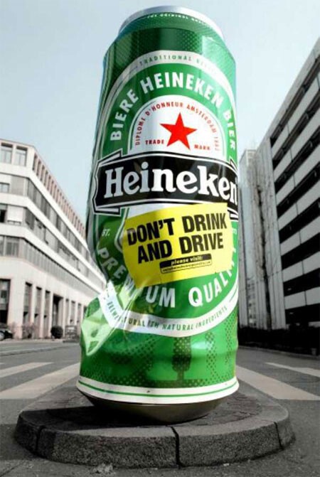 Огромная помятая банка пива Heineken из Швейцарии напоминает, что нельзя пить за рулем.