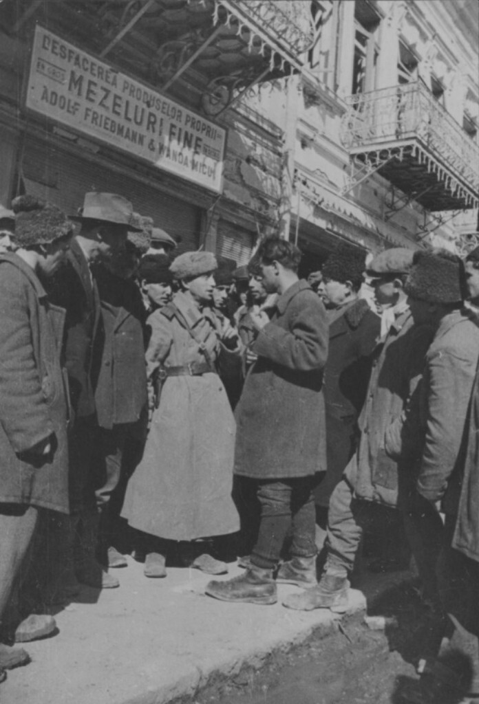 Советский офицер общается с жителями освобожденного Бухареста на городской улице.