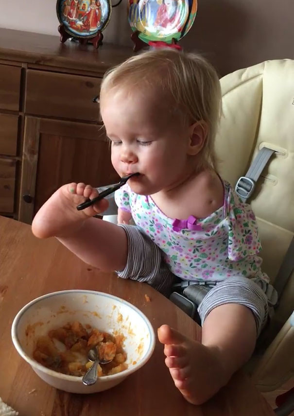 Эта маленькая девочка родилась без рук, но научилась кушать при помощи ног