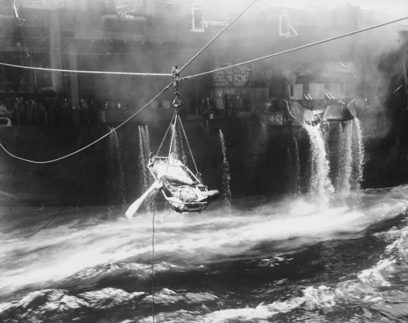 Транспортировка раненого члена экипажа авианосца "Банкер Хилл" (Bunker Hill (CV-17) на легкий крейсер Wilkes Barre (CL-103), 1945 год.