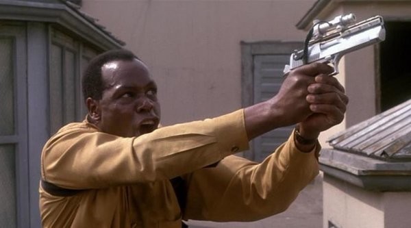 Пистолет Desert Eagle 44-го калибра с лазерным целеуказателем в руках Майкла Харригана (Дэнни Гловер). Фильм «Хищник 2» 1990 год.
