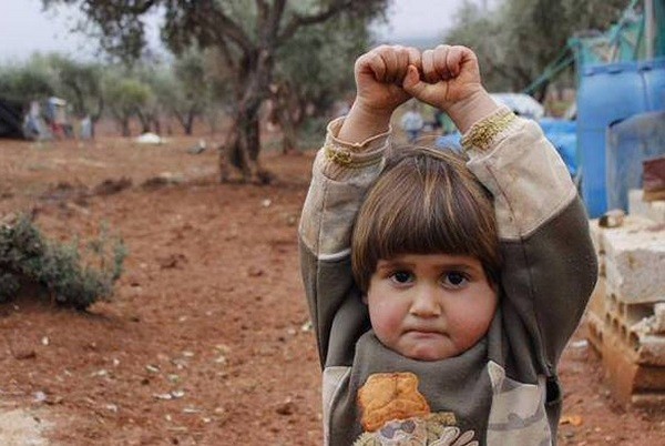 Сирийская девочка ошибочно принимает камеру за оружие и сдается, поднимая руки.