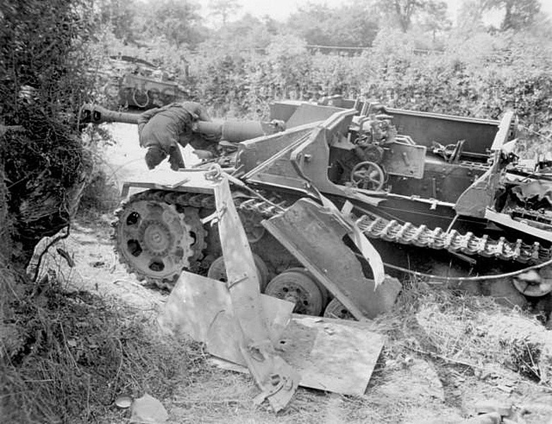 Взорванное немецкое штурмовое орудие StuG III и тело погибшего немецкого танкиста.