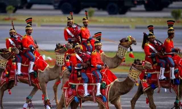  Волынщики военного оркестра пакистанских пустынных рейнджеров на верблюдах на параде в честь Дня Пакистана. Исламабад, Пакистан, 23 марта 2015 года