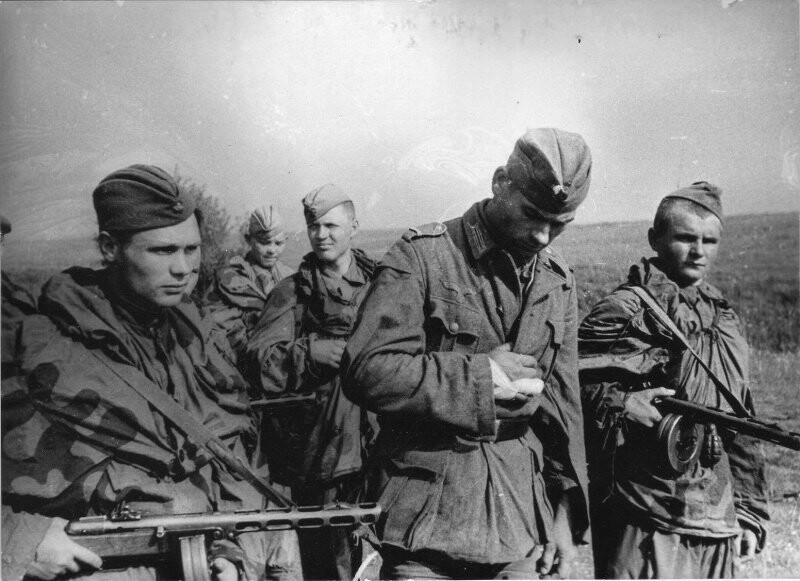 Советские разведчики ведут захваченного в плен немецкого солдата. 1944 год.