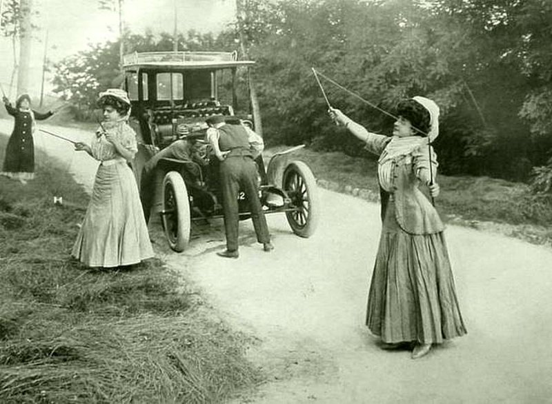 Три женщины играют с игрушками, а два мужчины пытаются исправить свою машину, Англия, 1908 год. ( С тех пор ничего не изменилось !!)