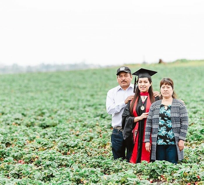 Выпускница университета сфотографировалась с родителями на фруктовом поле, где они работали, чтобы обеспечить ей лучшее будущее