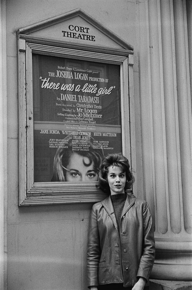 Актриса позирует на фоне афиши пьесы "Жила-была маленькая девочка"