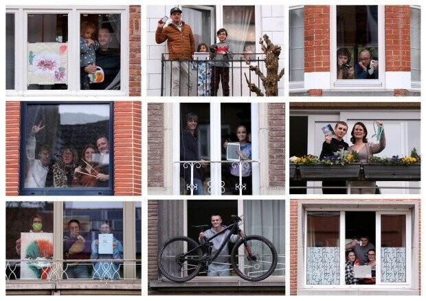 Бельгийцы позируют на балконах и в окнах своих домов, показывая важные для них предметы