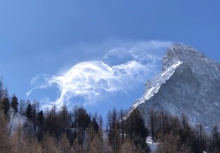 Сильный ветер способен сдуть с горных склонов так много снега, что издалека они видны как еще одни горы ил облака