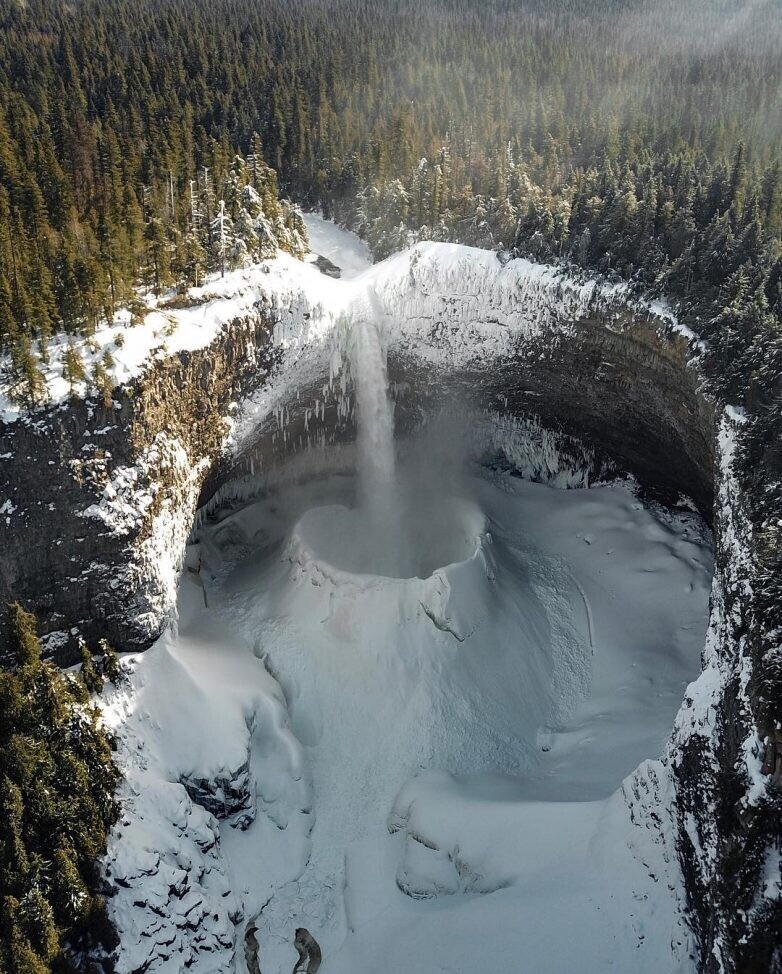 Потрясающее зрелище, которое создала замерзшая вода. Именно она образовала ледяной кратер в водопаде.