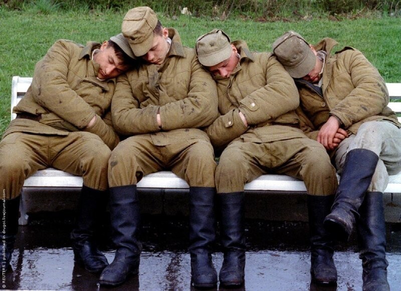 Солдаты, принимающие участие в подготовке парада в честь Дня Победы, отдыхают на лавочке в парке. Москва, 6 мая 1994 г.