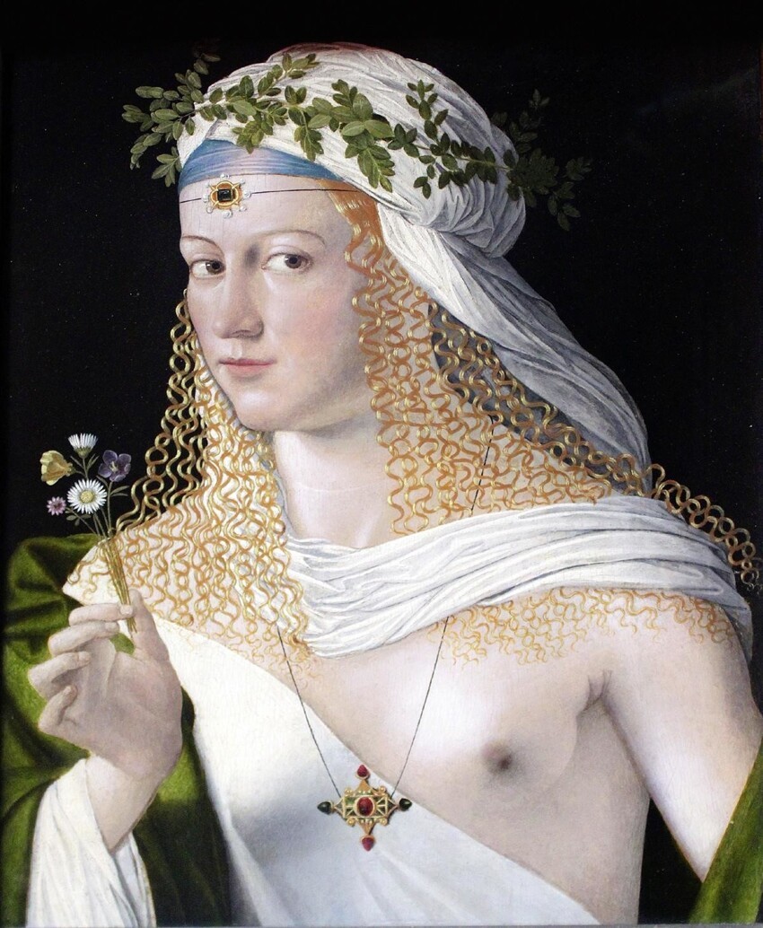 Лукреция Борджия везде описана как невероятная красавица. Так ее изобразил Бартоломео Венето. Портрет дамы в образе Флоры. Около 1520 года.