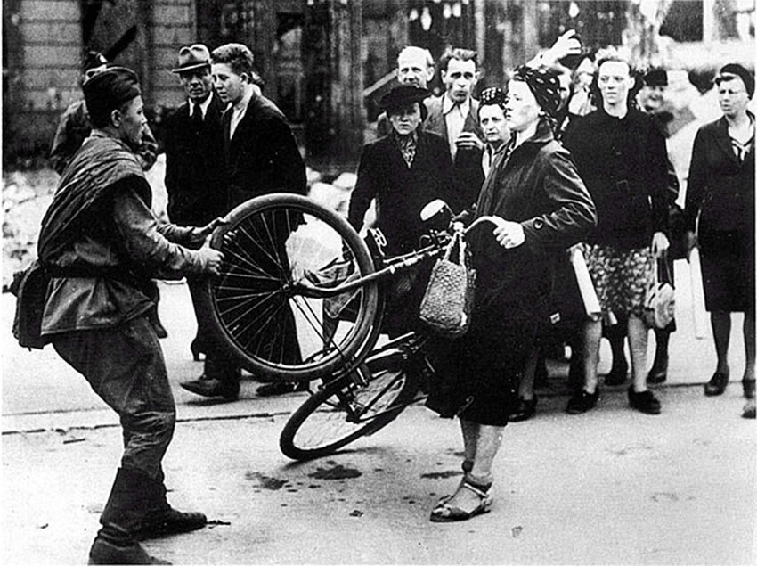 Это фото часто можно видеть с подписью "Советский солдат отбирает велосипед у немки"
