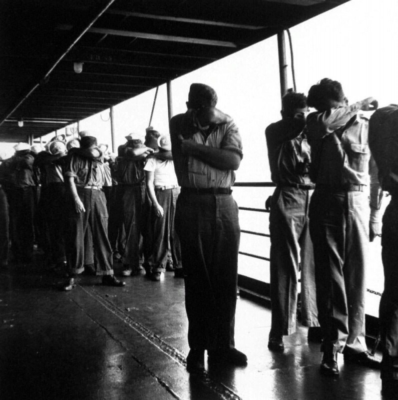 Американские моряки пытаются защитить свои глаза во время ядерных испытаний на атолле Бикини, июль 1946 года.