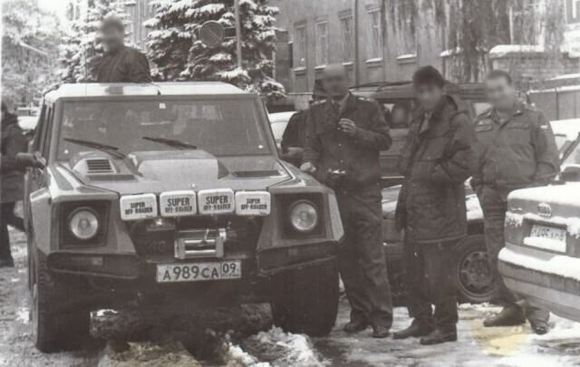 Милиционеры смотрят и фотографируют редкое авто Lamborghini LM002. Фотография сделана в середине 90-х в Черкесске практически сразу после попадания автомобиля в Россию. Сейчас машина находится в Сочинском музее.