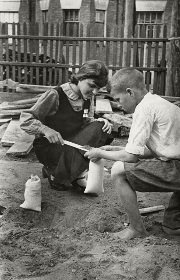 Валя и Толя Шаветевы наполняют мешочки песком, для тушения зажигательных бомб. СССР, июль 1941 года