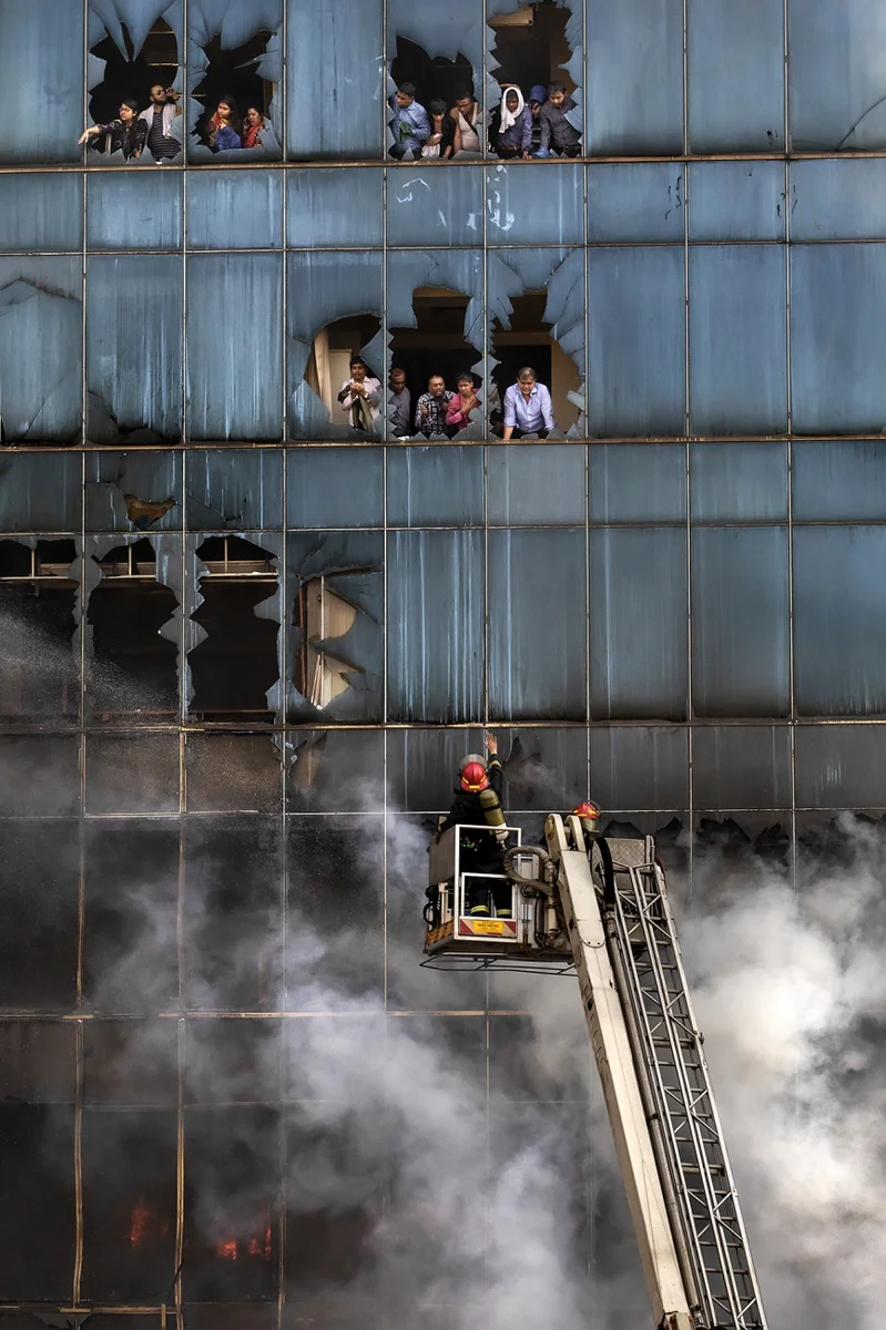 Бангладешские пожарные работают над тушением огня, в результате которого 25 человек погибли в офисном здании в Дакке. В нижней части здания горел огонь и люди оказались в ловушке.