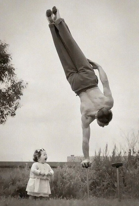 Папа демонстрирует свое мастерство к удивлению маленькой дочери в Мельбурне, Австралия, 1940-е