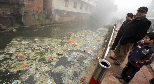 Жители Чжугао с отвращением смотрят на загрязненную реку, протекающую через их город