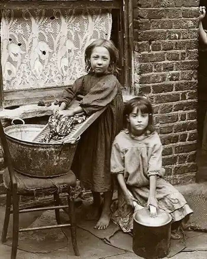 20. Две девочки стирают вещи на улице Лондона, 1900-е