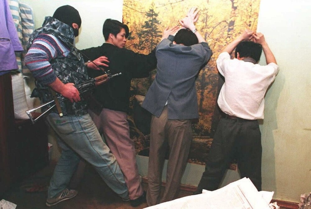 Сотрудник МВД задерживает троих вьетнамцев подозреваемых в торговле золотом, 1995 год