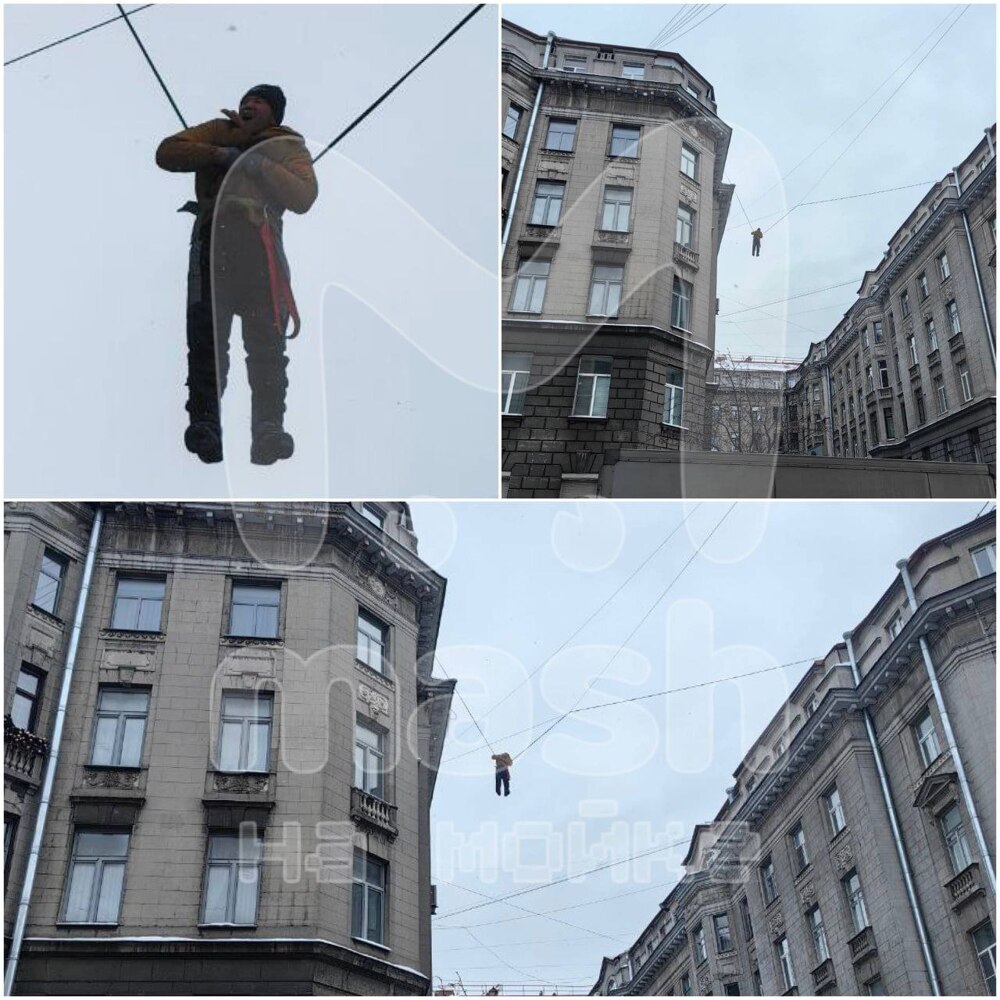 Дворник сорвался с крыши и повис на проводах